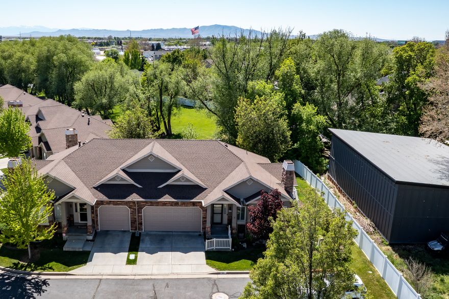 Beautiful end-row townhouse tucked away on a quiet private street within the community. Enjoy peaceful views and the soothing sound of the creek running behind the property from the covered deck-an ideal to relax or entertain. Inside, the home features a spacious and functional layout, including an oversized pantry on the main floor. The fully finished basement is designed for both comfort and versatility, complete with a wet bar, granite countertops, and an extra-large family room. Enjoy large designated food storage room, a private hobby room, and a generous finished cold storage space under the stairs. One of the rare units in the community offering a two-car garage.  Ideally located for shopping and easy commuting to Hill Air Force Base, Salt Lake City, and Ogden. Schedule a private showing today!