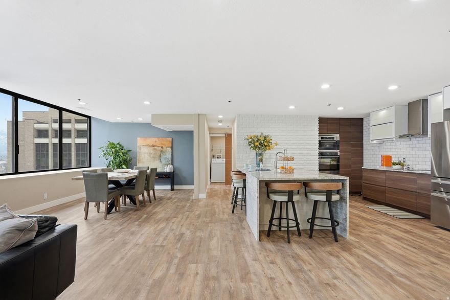 Stunning Downtown Condo with Breathtaking City & Mountain Views. Enjoy spectacular city and mountain views from this premier downtown condo, perfectly located in the heart of the city. This spacious Washington floor plan offers an open layout ideal for entertaining or simply enjoying the vibrant downtown lifestyle. Just a short walk from your door you'll find TRAX, City Creek Center, theaters, and a wide variety of fine dining and entertainment options. This beautiful corner unit features granite countertops, vinyl wood-style waterproof flooring, and nearly-new stainless steel appliances. Its prime corner location provides stunning views of the South valley and an eastern view of Mount Olympus and the City County Building, creating a truly special living experience. Residents enjoy access to outstanding luxury amenities, including a pool, hot tub, sauna, fitness center, racquetball courts, library, billiards room, an event/party room, and a rooftop barbecue area. The secure underground parking space for this unit is one of the best and largest in the complex, and the building provides 24-hour onsite security. This condo is available immediately. Come see it for yourself-you're sure to fall in love.