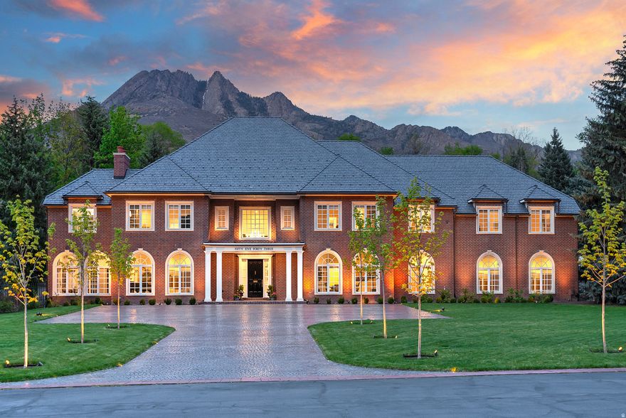 Offered for the first time on the MLS, this exceptional Georgian inspired estate is gracefully set on 1.13 acre within the Cottonwoods most prestigious gated enclaves. Thoughtfully reimagined from top to bottom-showcasing uncompromising craftsmanship and elegant design at every turn.  A grand entry welcomes with gleaming floors and a sweeping curved staircase, opening to an elegant living room accompanied by a refined music salon and an expansive formal dining room ideal for sophisticated gatherings. The chef's kitchen is beautifully appointed with top-tier appliances, a sunlit breakfast nook, and a well-appointed butler's pantry, seamlessly flowing into a warm and inviting family room with French doors that extend to the outdoor living spaces -perfectly designed for effortless entertaining. Additional highlights include an elevator, a richly detailed library/den with custom built-ins, generously sized en-suite bedrooms, 3rd level bedroom/apartment offers second kitchen. The primary suite is a true retreat, offering a spa-inspired bath w/heated floors and an extraordinary walk-in wardrobe reminiscent of a luxury boutique. The grounds are both private and serene, framed by towering pines and mature landscaping, enhanced by lush new lawn and an abundance of newly planted flowers, shrubs, and greenery. A new  DaVinci roof w/copper gutters, swimming pool and pool house complete this remarkable outdoor setting.