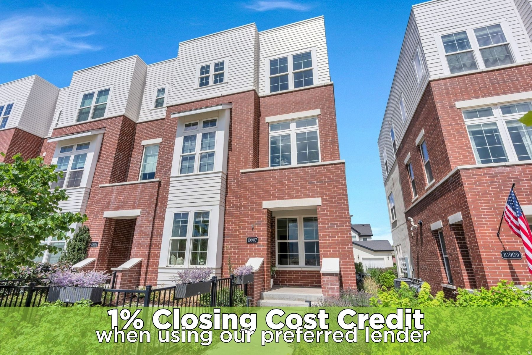 Three-story townhome with a brick and white siding facade