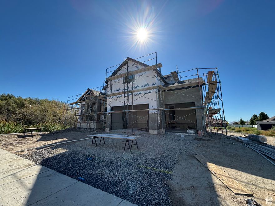 Stunning new construction in Lehi! This brand-new custom built home offers 7 bedrooms, 4.5 bathrooms, and luxury finishes throughout. Nestled on .38 acres, this home provides the perfect blend of elegance, functionality, and comfort. Step inside to soaring vaulted ceilings and breathtaking two-story windows that flood the space with natural light. The open-concept gourmet kitchen is a chef's dream, featuring a Forno 8-burner gas stove, a sleek range hood, a full-size commercial style fridge and freezer, double ovens and stunning designer cabinetry. The main-floor primary suite is a true retreat, offering a spa-like ensuite with a freestanding soaking tub, oversized shower, and walk-in closet. Upstairs, you'll find 4 additional bedrooms, 2 bathrooms and a second laundry room. The basement is being finished with a huge family room / entertaining space, fully kitchen, laundry hookups, 2 bedrooms and bathroom. Walkout to a covered patio and huge backyard!  Basement can be kept as a part of the home or used as an "ADU" (basement apartment.) There is ample storage throughout the home including a storage room. Entertain with ease on the covered deck, overlooking your expansive backyard-ideal for summer barbecues and outdoor fun. A 3-car garage ensures ample storage and parking, the extra height is perfect for overhead storage systems. . Located in a prime Lehi neighborhood with easy access to top-rated schools, shopping, dining, and Silicon Slopes, this home is the epitome of modern luxury.  Home is under construction, please schedule an appt to walk through.