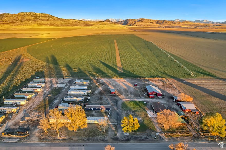 This listing is located in rural Box Elder County, Utah. The listing includes a total of seventeen rental units on 6.5 acres including Parcel 07-028-0016 (M&J Mobile Home Park), parcel 07-028-0004, and parcel 07-028-0003. All but one of the rental units are park-owned, and all but one of the park-owned rental units was a converted mobile home that now sits on a concrete foundation. All units have laundry hookups inside, a dedicated hot water heater, a dedicated central furnace, a dedicated propane tank, a dedicated power meter from Rocky Mountain Power, a dedicated irrigation water hydrant, and a dedicated culinary water connection from Ukon Water Company in Fielding. This listing includes a large underground community septic system consisting of eight total tanks which has been permitted by the Utah Department of Environmental Quality and recently inspected by a level 3 certified inspector. There are a total of four different pasture areas, there is a detached two-car garage with power and an automatic door opener, a detached 25X25 one-car garage with a combined shop that has power, a massive 60x50 barn with power, a chicken coop, a 45X40 workshop with HVAC, dedicated power meter, water, etc, and two sturdy livestock shelters in the pastures to keep your animals out of the weather. There are two underground water wells with two separate pump houses, and included in the sale are water right #29-4183, water right #29-3776, and water right #29-3933 totaling 15.87 ACFT and including 2.52 acres of irrigation water. All seventeen rental units have a dedicated culinary water connection from Ukon Water Company in Fielding. The farm portion of the property has previously hosted cattle, horses, sheep, goats, chickens, ducks, turkeys, a peacock, and pigs. The property is currently being used as a rental investment and there is professional property management in place. The property manager is willing to stay on with a new owner upon request. All current leases can be canceled with a 30-day notice upon the sale. Parcel 07-028-0016 is adjacent to 07-028-0004 and 07-028-0003. See also WFRMLS# 2046270, WFRMLS# 2046271, WFRMLS# 2046285, WFRMLS# 2046301, WFRMLS# 2046317, WFRMLS# 2046318, WFRMLS# 2046319