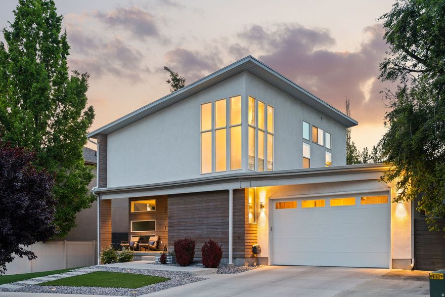 Welcome to this beautifully immaculate and modern energy-certified home in the highly sought-after Canyon Rim area of Millcreek. Filled with natural light and an open, airy feel throughout, this home blends style, function, and convenience in all the right ways. Thoughtfully designed, this floor plan features a rare 3-car tandem garage, offering plenty of space for vehicles, storage, or outdoor gear, plus an EV charging connection for added convenience. The kitchen is equipped with a premium dual range featuring a gas cooktop and electric oven and large island space.  Enjoy sitting on the large covered front porch with a xeriscaped front yard or into the back with a large outdoor sitting area ideal for relaxing evenings, hosting guests, or summer BBQs with the built-in natural gas hookup. Located just minutes from hiking and biking trails, parks, shopping, dining, and freeway access, this home offers the perfect balance of peaceful living and close to everything convenience.