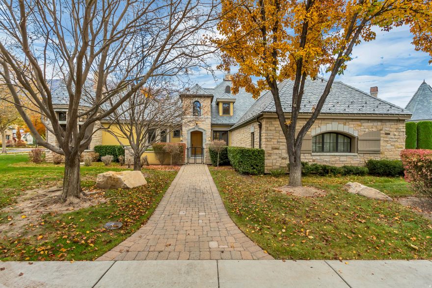 Located in the highly sought-after Stone Gate community, this beautifully designed 4-bedroom, 5-bathroom residence offers a rare blend of privacy, convenience, and scenic surroundings. Enjoy picturesque views from nearly every window and a peaceful setting just minutes from Sundance Ski Resort, Riverside Country Club, the Provo Riverbottoms, BYU, and more. The main level features soaring ceilings, expansive windows, and multiple gathering spaces ideal for both everyday living and entertaining. The well-appointed kitchen is equipped with Wolf stainless steel appliances and a Sub-Zero refrigerator and freezer, and flows seamlessly into the family room, breakfast nook, outdoor patio, and formal dining area. The main level primary suite provides a private retreat complete with a gas fireplace, and a spacious walk-in closet. Upstairs, a loft-style bedroom with hardwood floors and a full bath offers flexibility for guests or additional living space. The walk-out basement includes two additional bedrooms, a theater room wired for surround sound, a versatile flex room, and generous storage space. From the lower-level patio, enjoy direct access to the backyard, community stream, and nearby walking trails, creating a seamless connection to the outdoors. The home also features a 3-car garage, multi-zone HVAC, and a Control4 lighting and sound system for modern comfort and convenience. With snow removal of roads and driveway as well as lawn maintenance included, this property combines prime location, privacy, and low-maintenance living. From the secured access to the serene setting of water flowing in the backyard, custom features throughout, this home is sure to impress. Reach out today for a private showing. Buyer/Buyer's Agent to verify all information.