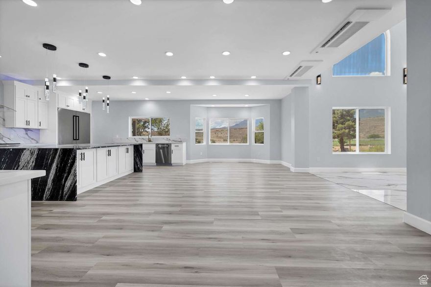 Welcome to 476 Spring Drive, a stunningly reimagined custom estate tucked away on a quiet, upscale street in Toquerville, Utah, where custom homes sit on generous lots, and peace, privacy, and panoramic beauty abound. This fully transformed 8,230 sq ft luxury residence, plus a 2,700 sq ft garage, sits on one of the most desirable lots in the area and includes the parcel directly across the street, forever protecting your incredible views of Southern Utah's red cliffs and desert terrain.  Located just minutes from Interstate 15 and a quick drive to Zion National Park, Sand Hollow Reservoir, and downtown St. George, this home is as perfectly situated as it is perfectly built.   Ultimate Privacy & Street Presence The home is flanked by two separate driveways one servicing the main house and garage, and the other dedicated to the casita. A bold sense of arrival greets you at the oversized custom double front doors, leading into a breathtaking two-story foyer with gleaming marble-look tile flooring, arched picture windows, and a striking multi-tiered chandelier that sets the tone for the rest of this one-of-a-kind property.   8,230 SF of Refined Interior Living Every square foot of this home has been redesigned with scale, flow, and finish in mind:  6 oversized bedrooms, each with a private en-suite bathroom  2 additional half baths  A large finished basement area ready to be transformed into a home theater, gym, or wine cellar  Custom built-ins, dual living rooms, and oversized entertaining spaces designed for flexibility, function, and beauty  Framed with 2x6 construction in many key areas and finished with 5/8" drywall, this home is not only expansive but highly durable, safe, and well-insulated.   Gourmet Kitchen & Entertaining Hub At the heart of the home lies a showpiece chef's kitchen, designed to impress with every detail:  Striking black waterfall island with pendant lighting  Full-slab marble-look backsplash and under-cabinet LED accent lighting  Commercial gas range, dual ovens, oversized fridge, and dual dishwashers  Custom display cabinetry, a walk-in pantry, and a dedicated wet bar  Adjacent open living areas flow seamlessly for gatherings large or small.   Designer Fireplaces & Custom Finishes Every living space is anchored by a distinctive fireplace:  A oversized-recessed electric fireplace in the upstairs living room  A traditional gas-burning fireplace in the downstairs great room with dramatic stonework  A second gas-burning fireplace wrapped in marble-like stone, located in the casita living room for cozy comfort  R50 attic insulation, R23 exterior insulation, and R15 interior wall insulation  Energy-efficient lighting and thoughtful system zoning for long-term comfort and savings   Privacy, Protection & Long-Term Value The north side yard is enclosed by a 206-linear-foot custom split-face block masonry wall, offering exceptional privacy and structural durability. Final stucco work and landscaping are currently in progress, ready for personalization.  The sale also includes the adjacent parcel across the street, preserving the stunning views forever and creating a sense of protected space that few homes can offer.   Unbeatable Southern Utah Location 5 minutes to I-15 access  20 minutes to Sand Hollow and Quail Creek Reservoir  10 minutes to Zion National Park  Under 30 minutes to St. George's dining, shopping, and medical hubs  Whether you're seeking a multi-generational compound, executive retreat, or one-of-a-kind luxury primary residence, 476 Spring Drive is a rare and refined offering in one of Utah's most iconic landscapes.  This is not just a renovation, it's a reinvention. Welcome to your next chapter, Welcome to 476 Spring Drive!