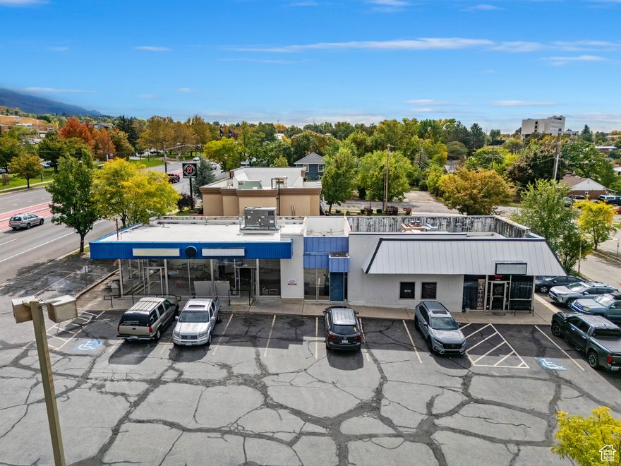Exceptional commercial property located directly across from Weber State University on Harrison Boulevard. This versatile space is ideal for retail, office, or restaurant use, offering outstanding visibility and access in one of Ogden's most desirable corridors. Situated just steps from the new Ogden Express (OGX) Station at Harrison and 36th Street, the property benefits from strong traffic flow and convenient public transit connectivity. Neighboring businesses include Weber State University, McKay-Dee North Campus, Jimmy John's, and FedEx. Features include ample paved parking for employees and customers, excellent signage potential, and high exposure along a major thoroughfare. Whether for owner occupancy or as a solid investment, this property presents a rare opportunity in a premier location