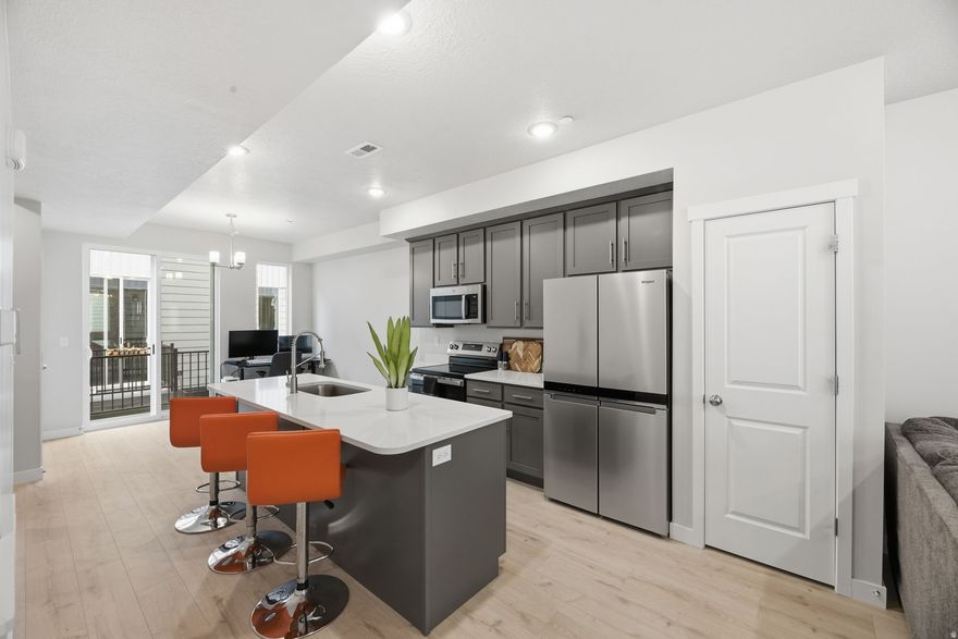 PRICE REDUCED | MOVE-IN READY 2024 TOWNHOME | FHA APPROVED Modern townhome in Salt Lake City offering unbeatable value, low-maintenance living, and investment potential. Built in 2024, this move-in ready home features an open-concept floor plan with a spacious Great Room, oversized 8' kitchen island, quartz countertops, stainless steel appliances, and upgraded shaker cabinets. Perfect for first-time home buyers, house hackers, or investors, this property includes a private ensuite bedroom ideal for roommates or rental income. Upstairs features 9' ceilings and a functional layout designed for comfort and privacy. Additional highlights include a private deck, 2-car tandem garage with extra storage or flex space, and fiber internet included in HOA. FHA approved, making financing more accessible. Located just minutes from downtown Salt Lake City with easy access to I-15, shopping centers, restaurants, and major employment hubs. Ideal for commuters and anyone looking for convenience and modern living.