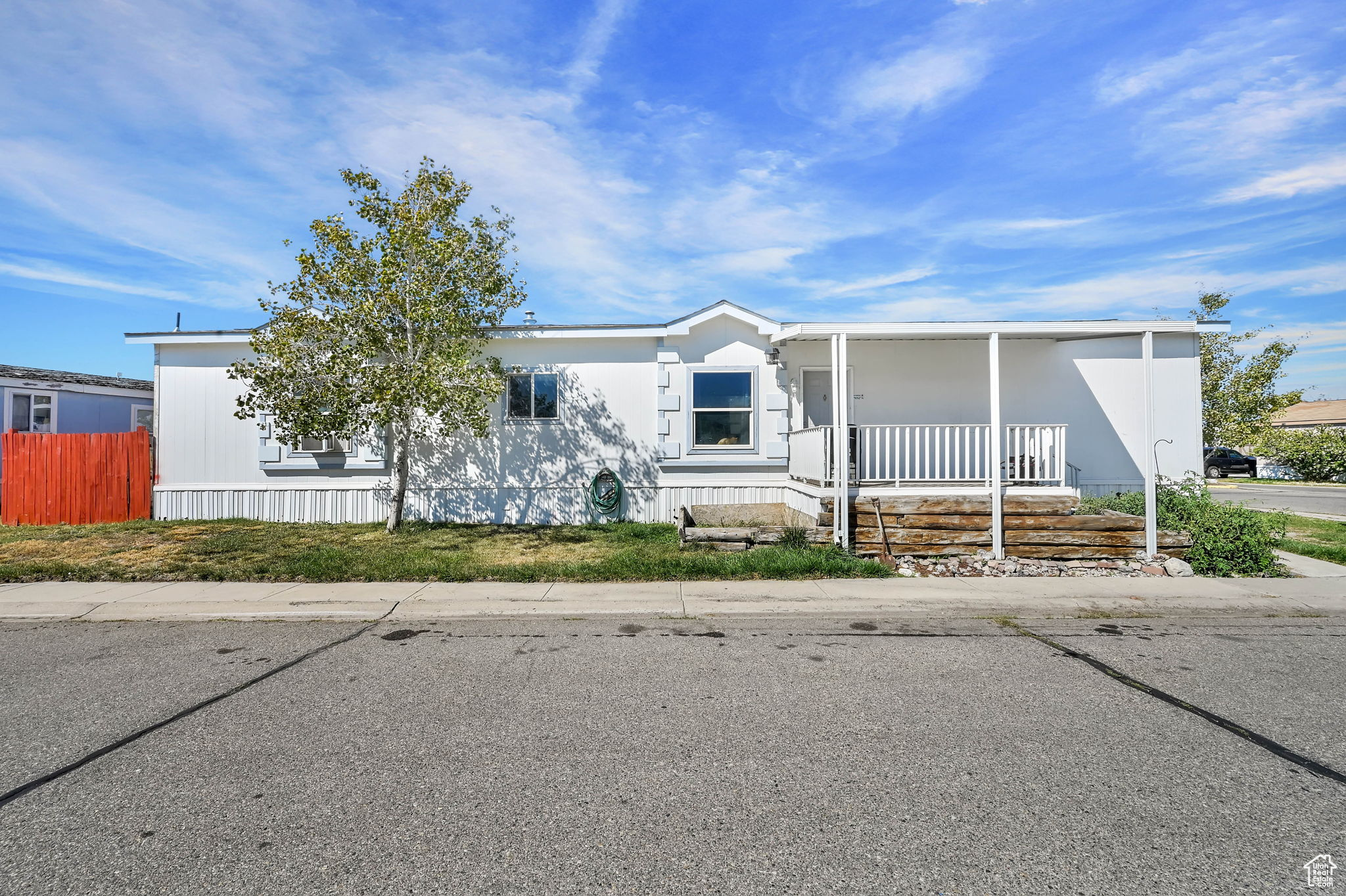 Discover a rare find in the Hacienda neighborhood of West Valley City-a spacious 1200 sq. ft. 16 ft wide single, larger than many in the community. This home offers 3 bedrooms and 2 bathrooms, providing plenty of room for comfortable living. Inside, you'll enjoy a functional kitchen and living room layout, while outside you'll find a fenced backyard for added privacy, a covered carport, and the bonus of being adjacent to the community clubhouse for easy access to neighborhood amenities. With its unique size and convenient location, this home is a great option for anyone looking for value and space in West Valley. HOA fee covers parcel rent and sewer and club amenities.
