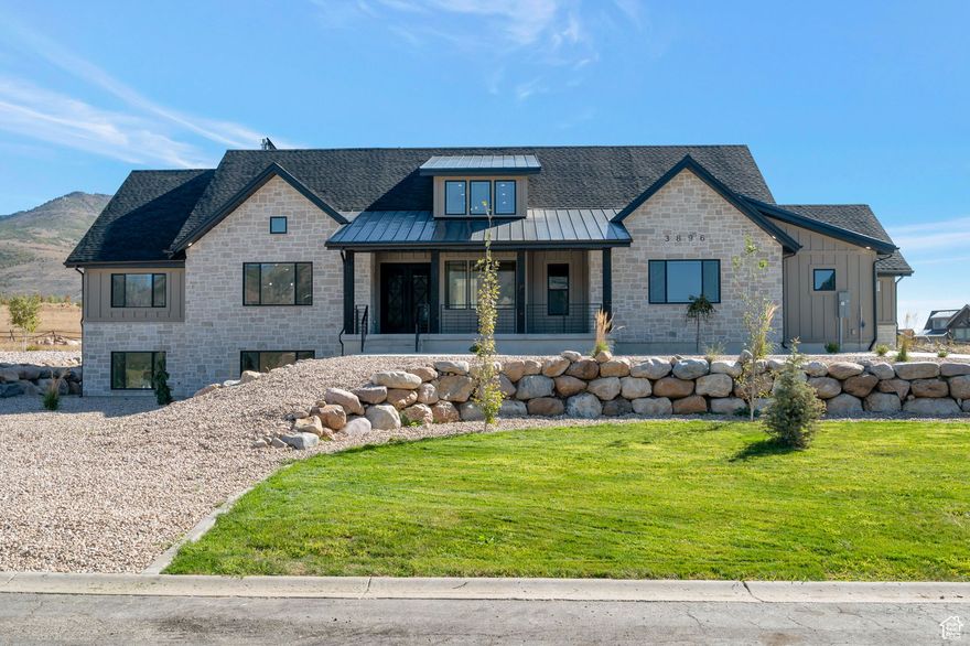 Elegant Mountain Rambler in Eagle Ridge Estates! Welcome to this beautifully designed mountain rambler nestled in Eden, UT.  With stunning mountain views and thoughtful finishes throughout, this home perfectly blends luxury, comfort, and functionality. Step into the open-concept kitchen and grand great room featuring soaring vaulted ceilings, a cozy fireplace, and oversized sliding glass doors that lead to a covered patio -ideal for indoor-outdoor living and entertaining. The chef's kitchen has upgraded appliances, an oversized island, and a large picture window framing breathtaking mountain vistas. Just off the kitchen, a spacious butler's pantry offers abundant storage, a second dishwasher, double ovens, a microwave, prep sink, and ample counter space - truly an entertainer's dream! The luxurious primary suite offers serene mountain views, private access to the backyard through sliding glass doors, its own fireplace, a spa-like en-suite with a soaking tub, an oversized multi-spray shower, and a massive walk-in closet. The fully finished basement expands your living space with 2 beds/2baths a dedicated gym, theater room, rec room, and a convenient kitchenette perfect for entertaining. Oversized 3 car garage and RV parking!