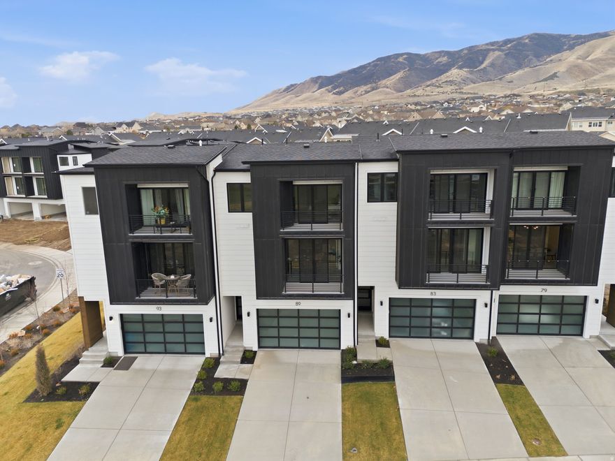 ** The model home is located at 64 Watson Dr. It is open Monday through Friday 11:00 am- 6:00 pm and Saturday from 10:00 am to 5:00 pm. ** We have 2 and 3 bedrooms of this model available at the same price. Experience elevated living in this stunning three-story luxury townhome located on the TalonsCove Golf Course and just moments from Utah Lake. Nestled in a prestigious resort-style community, this home offers the perfect blend of luxury, recreation, and scenic beauty. The second floor showcases a bright open-concept layout with a spacious kitchen, dining, and living area. Floor-to-ceiling windows on both ends fill the space with natural light, creating an inviting and airy environment perfect for entertaining or relaxing.  This exceptional HOA community offers incredible amenities including a year-round natural heated mineral pool fed by local hot springs, a second outdoor swimming pool, two clubhouses with workout facilities and event space, and a private boat dock marina on Utah Lake. Residents also enjoy a large pavilion for hosting gatherings, multiple parks and playgrounds, and miles of connected walking and nature trails throughout the community.  The home itself is filled with premium and thoughtful upgrades including semi-custom soft-close cabinetry, 3 cm quartz kitchen countertops, a vent above the microwave, and high-end window and sliding glass door packages that enhance the home's modern design. The staircase is wider than standard homes and features a large statement window above the stairs that fills the space with light and adds to the luxurious feel.  Additional upgrades include 8-foot doors throughout, custom lighting, extra can lighting with ceiling fan wiring, soundproof walling in the toilet area for added privacy, internet access points installed in the walls, and plumbing for a water softener. The tankless water heater provides efficiency and convenience.  The garage is finished with durable epoxy flooring, an aluminum and glass garage door, added lighting, and a security camera for peace of mind.  Enjoy luxury living just steps from TalonsCove Golf Course and minutes from the water, where resort-style amenities, scenic surroundings, and modern design come together to create an exceptional place to call home.