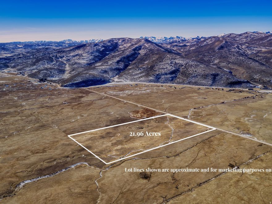 This exceptional 22-acre parcel on coveted Democrat Alley offers stunning mountain and valley views. Located right down the street from Ballerina Farm, this rare Summit County opportunity combines prime location with quiet seclusion. The property has already been subdivided into two buildable lots of 11 acres each and includes 14.3 acre-feet of water shares. Crooked Creek runs right through the property! The AG/Grazing-40 zoning is a significant advantage, as this subdivision allows building on 11-acre parcels while surrounding properties require the standard 40 acres to build. Perfect for a custom estate, horse property, or agricultural use, this property offers the space and privacy Summit County buyers are seeking. The location provides convenient access to world-class amenities with Park City just minutes away and Salt Lake City approximately 45 minutes. Seller financing is available. Please contact the listing agent to discuss terms.