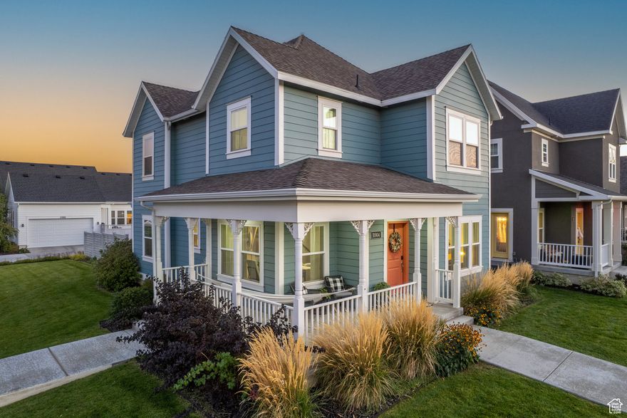 This stunning 4-bedroom, 4-bathroom home is perfectly situated in an amazing Daybreak location, right across from a spacious green area and a short walk to the new Bees ballpark! This classy 2-story home will charm you with its dreamy wrap-around front porch with hammock, interior brick accent walls, arched walkways, and stylish tile floors and surrounds in the bathrooms. Paid off solar panels keep the utility bills low! The large, abundant windows, all fitted with shades or drapes, offer beautiful outdoor views and fill the home with natural light. The kitchen includes all stainless-steel appliances, granite countertops and under-cabinet lighting. The finished basement provides an additional living space with a cozy fireplace, a private bedroom, a full bathroom, a utility room with a sink, and an impressive cold storage area. Upstairs, there are three more bedrooms, including the primary suite with an en-suite bathroom featuring a soaking tub, separate shower, double vanity, enclosed toilet room, and a spacious walk-in closet. The garage impresses with tall ceilings, epoxy floors, overhead storage, and a 50 amp EV charger. Additional upgrades include a whole-house attic fan, a Wi-Fi-enabled garage door opener, and a smart thermostat. Don't miss your chance to love where you live and experience all that the Daybreak lifestyle has to offer.  Make sure to check out the 3D tour! All information to be verified by the buyer.