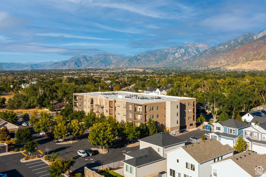 This exceptional condo at Rockwell Square is located just steps from shopping, dining, parks, and everyday conveniences, with easy access to Salt Lake City and Provo. It delivers 1750 square feet of luxury single-level condo living with the space and comfort of a house, without the maintenance, and with elevator access.  The open-concept layout is both elegant and highly functional, featuring 9-foot ceilings, wide hallways, and windows that capture west-facing views of the Salt Lake Valley. The gourmet kitchen is a true showpiece with solid-surface countertops, stainless steel appliances, abundant cabinetry, and a walk-in pantry and extensive storage. The adjacent dining and living areas flow seamlessly, creating an ideal space for both entertaining and everyday living.  Retreat to the luxurious primary suite, complete with a spa-inspired bathroom featuring dual vanities, a jetted soaking tub, separate shower, and an enormous walk-in closet. The secondary bedroom functions as a second primary suite with its own en-suite bathroom. A third flex room with access to a half bathroom offers versatility as a home office, guest room, or creative space.  Additional highlights include an oversized laundry room, secured building access, and dedicated parking stall in a gated garage. Recent updates include new carpeting.