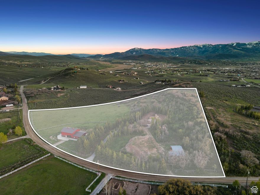 A rare opportunity to build your dream estate on 12.48 improved acres in Silver Creek Estates. This is not a vacant lot-the previous home has been removed, but the property is fully equipped with a 2,880 sq ft roper-style pole barn including 1,000 sq ft of "conditioned space", a 1,500 sq ft run-in shed, private well, water meter, holding tank, and three gated, and one gravel, all established driveways. Fully fenced with traditional Buck & Rail Fencing, panoramic views of the Wasatch and Uinta mountain ranges. Enjoy privacy, functionality, and endless potential just minutes from the heart of Park City. Buyer to verify all information.