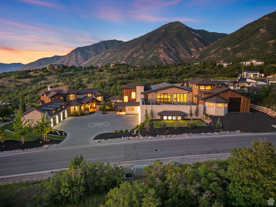 Welcome to one of Utah's most extraordinary private estates, set within the prestigious gated community of Summit Creek in Woodland Hills. Designed by renowned architect Kevin Price through the vision of Real Estate YouTube star Kris Krohn, this masterpiece was created to exceed expectations with limitless potential. The compound is thoughtfully composed of two distinct wings that together offer an unparalleled living and entertaining experience. The 8,500-square-foot private family wing is a stunning retreat in itself, featuring five bedrooms, a gourmet kitchen, a spectacular great room with double-story glass walls framing panoramic mountain vistas, an elegant office, and refined living spaces. This wing also includes a 3-car garage for daily convenience. The recently completed 20,000-square-foot addition is where the estate transcends anything else on the market. Conceived as a place where imagination becomes reality, this wing delivers an almost cinematic level of luxury and flexibility. At its heart is a show-stopping indoor pool with a world-class hydraulic floor system that transforms into a grand ballroom-an engineering marvel inspired by The O Theater at the Bellagio in Las Vegas. An ultra-luxury spa retreat offers a dry sauna, steam room, massage room, float room, and more, creating a true wellness destination at home. The addition also includes a true executive office suite and separate conference room, ready to host everything from corporate meetings to creative collaborations, along with a dedicated racquetball space for sport and recreation, and large chef's kitchen for entertaining. Throughout the space, stunning galleries and walls are designed to showcase art, crystal collections, or installations, giving it the feel of a private museum. For car enthusiasts, a sprawling display garage accommodates 13 cars, complete with lounge areas and elevated presentation platforms perfect for collectors or those seeking to impress. Additional unfinished space offers the opportunity to build the ultimate gym, including a professional-grade triple-story climbing wall. This estate is designed to suit a visionary buyer-whether it becomes an extended family compound, a corporate retreat, an entertainer's dream, or the ultimate venue for any celebrity to host podcasts, productions, and events on an epic scale. Beyond the property itself, Summit Creek offers Utah County's premier gated mountain living, with amenities that include pickleball courts, a state-of-the-art fitness center, an outdoor pool facility with breathtaking mountain scenery, a community clubhouse, and an extensive network of private trails and open space. Residents enjoy excellent access to everything that makes Utah special, with a short drive to Provo Airport, world-class skiing at Sundance Resort, top-tier medical facilities, shopping, dining, and endless outdoor recreation. This is not just a home, it is a private kingdom of possibility.