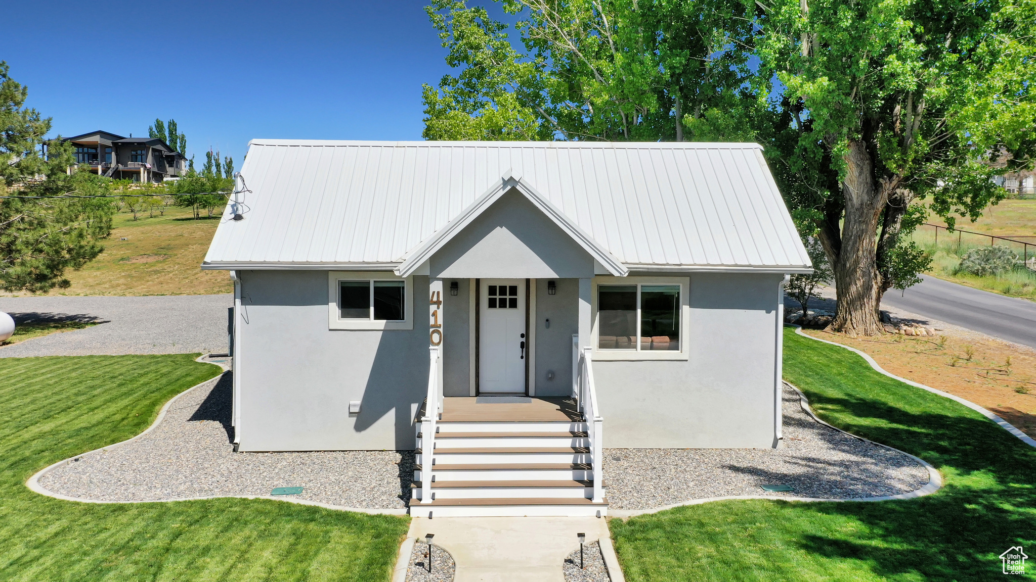 Completely renovated home in 2022 with all new Kitchen, bathrooms, plumbing, electrical, lighting, sheetrock, flooring, HVAC, insulation, windows, roof, septic system, etc.  Only 10 minutes from Walmart and other shopping, but located in quiet Genola. There is tons of lights through out the home, Double Shower heads in main bath.  Sprayed in Insulation in attic for temperature controlled storage.  You will love all of the trees, large shade/pine trees around the home for relaxation, 50 Peach Trees, 3 almond and 10 other fruit trees. Drip irrigation with water shares for the fruit trees. RV Electric hookup and sewer dump. Finished Root Cellar for additional storage along with the shed.