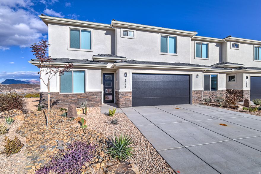 This brand-new, never lived in end-unit townhome in Hurricane, Utah offers stunning panoramic views of Zion National Park, Smith Mesa, Pine Valley Mountain, and the vibrant Red Cliffs Desert Reserve. Enjoy the views from an expansive rooftop deck that has to be experienced in person to be appreciated! An additional private fenced and gated patio makes a perfect spot for outdoor living. The main level features a primary ensuite bedroom and an office. 3 additional bedrooms plus a family room are located upstairs. Never lived in, this home also includes 2.5 bathrooms, an attached 2-car garage, remote window shades, and even a tankless water heater!  Long-term rentals are allowed (no short-term rentals). 2025 taxes are currently based on vacant land. Call or text Sarah at 435-773-3905 for showings and details