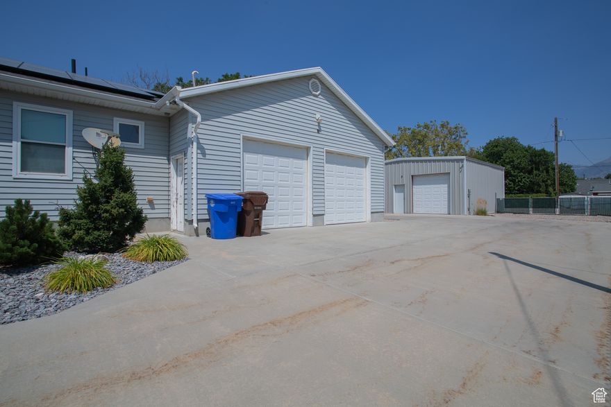 TALK ABOUT GARAGE SPACE! How often do you find almost a half acre lot in the middle of the city?! Complete paid off solar to run the house!  And garages...3 car attached garage, stubbed for gas heat and then a massive at least 4 car garage/shop detached with the gas stubbed also.  Awesome!  There is still a lot of land to spare to the east of the detached garage that so much could be done with. The home is a large over 3600 square foot rambler with a mother-in-law apartment planned for the basement. With separate entrance.  Finished completely downstairs is a family room with kitchenette, but all of the rest of the rooms are ready for drywall, paint, and flooring. Great possible income potential? Main floor boasts 3 bedrooms, with a large master and en suite. Kitchen had a built in desk and lots of cabinets. Crown molding. Current owner was a master electrician and this amazing home shows all of the benefits of that with dimmer switches, internet set ups, and so much more.  Really needs to be seen to understand.  Such a unique and great home in the heart of Midvale.  Call today for an appointment!