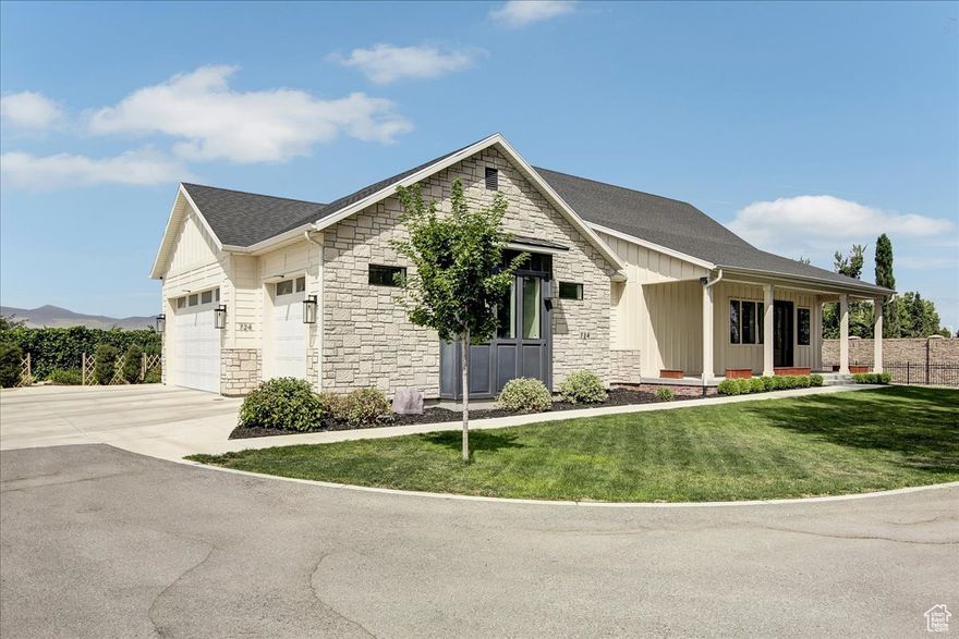 Major price reduction, motivated seller! Nestled down a quiet private lane, this exquisite home is a true hidden gem-handcrafted by Solid Group Utah, one of the state's premier custom home builders. Set on a large, beautifully lot surrounded by mature trees, this residence offers the perfect blend of seclusion and convenience, located just minutes from freeway access, top-rated restaurants, grocers, and shopping. Boasting generous square footage, the home showcases exceptional architecture and thoughtful design throughout. The exterior is a striking blend of stone, brick, smooth stucco, and Hardie board, creating a timeless curb appeal. Two grand covered patios-one at the front and one at the rear-invite seamless indoor-outdoor living. The back patio offers unobstructed views of the Oquirrh Mountains, providing the perfect backdrop for peaceful evenings and unforgettable sunsets. Inside, every detail reflects craftsmanship and quality. Enjoy engineered hardwood floors, stained wood ceiling beams, and custom inlayed cabinetry. The gourmet kitchen includes a hidden walk-in butler's pantry and quartz countertops, complemented by high-end fixtures and designer tilework. Each bedroom features a spacious walk-in wardrobe, while the award-winning master bath is a sanctuary of luxury and style. This remarkable home delivers the serenity of a countryside estate with the access and amenities of city living. A rare opportunity for those seeking elegance, space, and privacy in a coveted location.
