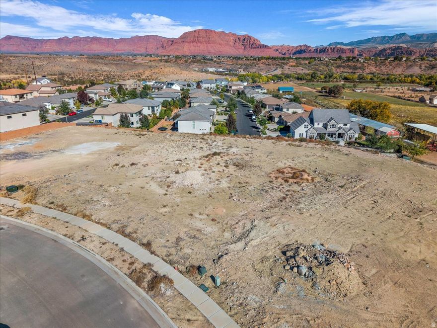 Build your dream home on this .77 acre pad ready lot offering panoramic views of Red Mountains, Pine Valley Mountain, Snow Canyon and surrounding valley. This flat, ready to build property provides the perfect setting for a luxury custom home! CC & R'S available. No HOA!!