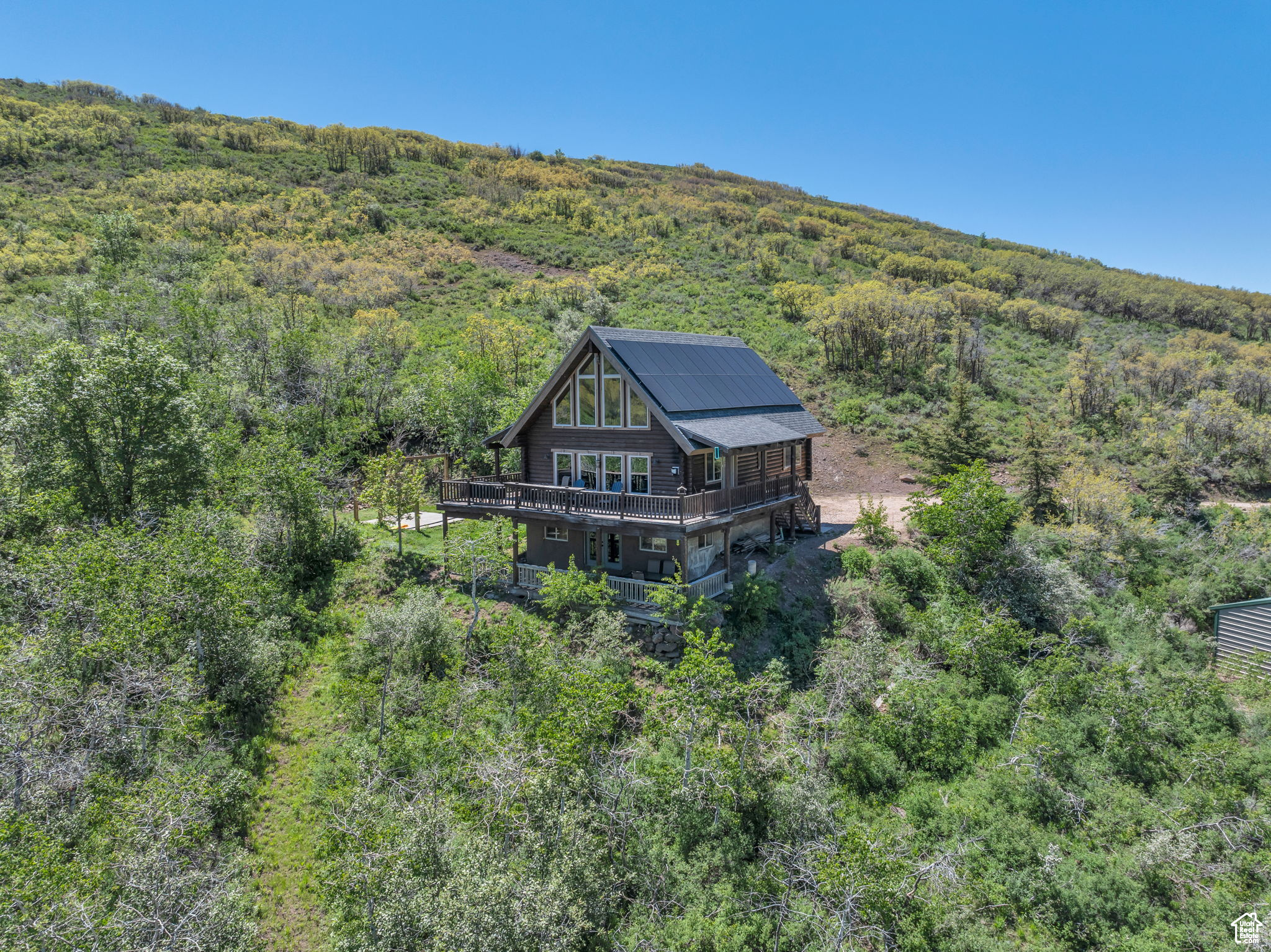 Get away to your own piece of Utah mountain heaven! This 40 acre cabin property sits nestled in a beautiful mountain valley just a few miles from Park City, Jordanelle Reservoir, and some of the nicest golf courses in Northern Utah. It is completely off grid with a paid off solar system, back up propane generator and its own well. This home is furnished and is a fully functioning Short Term Rental making it the perfect property for someone who wants a cabin to escape to that can also bring income. Enjoy the zip line, outdoor deck views, fire pit, and quick access to all of your favorite activities. Hangout in one of the 3 living areas. Enjoy the breathtaking views from the floor to ceiling windows while the kids play upstairs in the super cool bunk room. This is a perfect property for the family to escape to and may also be a great investment given its proximity to some of the most visited and expensive areas of the state.