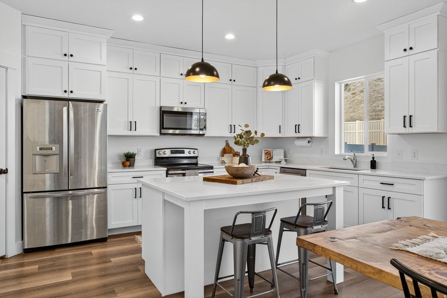 Discover the perfect blend of style, comfort, and functionality in this stunning 2022-built home. The open-concept main floor welcomes you with 9-foot ceilings, luxury vinyl plank flooring, and tons of natural light. A gorgeous designer kitchen featuring shaker-style upper cabinets, extended island with seating, quartz countertops, and abundant storage-ideal for cooking, entertaining, and everyday living.  Upstairs, you'll find 4 spacious bedrooms and two full bathrooms, including a serene Primary Suite with a huge walk-in closet, euro-glass shower, and dual sinks. The fully finished and fenced backyard is your private retreat, complete with a custom deck, garden beds, and peaceful rural views and sunsets. Plus, no back neighbors!  Every detail of this home has been thoughtfully designed for beauty, flow, and modern living. Homes like this rarely come along-schedule your private showing today!  *Home is Agent Owned.