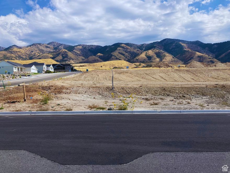 With all the groundwork done, you'll be able to start your project without delays, offering a seamless transition to build your dream home. Lone Cedar, a new community in Hyde Park City, offers stunning westward valley views and majestic eastward mountain scenery toward Hyde Park Canyon. This lot is 0.48 acres, with gentle slopes, providing versatile building options. Designed to foster an attractive community, Lone Cedar ensures ample space between lots and prioritizes water conservation with native, drought-tolerant landscaping. Buyer will be required to build with Top Notch Construction.