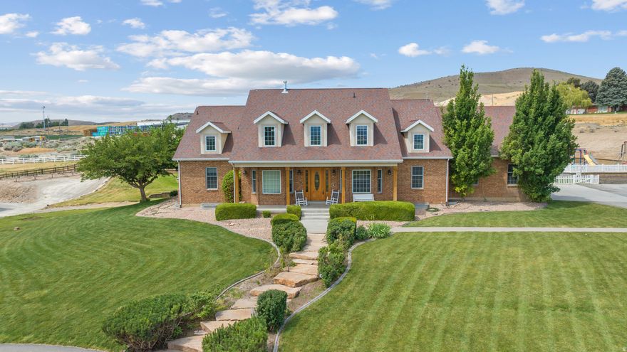 Beautiful 8,500+ sq ft home on 5.32 acres with stunning mountain & valley views! Features 8 beds, 5 full & 2 half baths, open kitchen with double ovens, 2 dishwashers & large pantry. Main-floor primary suite with walk-in closet & deck access. Finished basement with theater, kitchenette & separate entrance-ADU potential. New HVACs, tankless water heaters & 40-kW solar with battery, fenced pasture,  two outbuildings- 30' x 60' with a 100-amp power service building and a 66' x 60' shop with 200-amp power. We are not done yet!  Greenhouse, grow boxes & root cellar. Zoned for horses/livestock, near trails. Assumable 2.87% VA loan (Approximately 900,000 -non-vets eligible). Fiber internet coming soon!