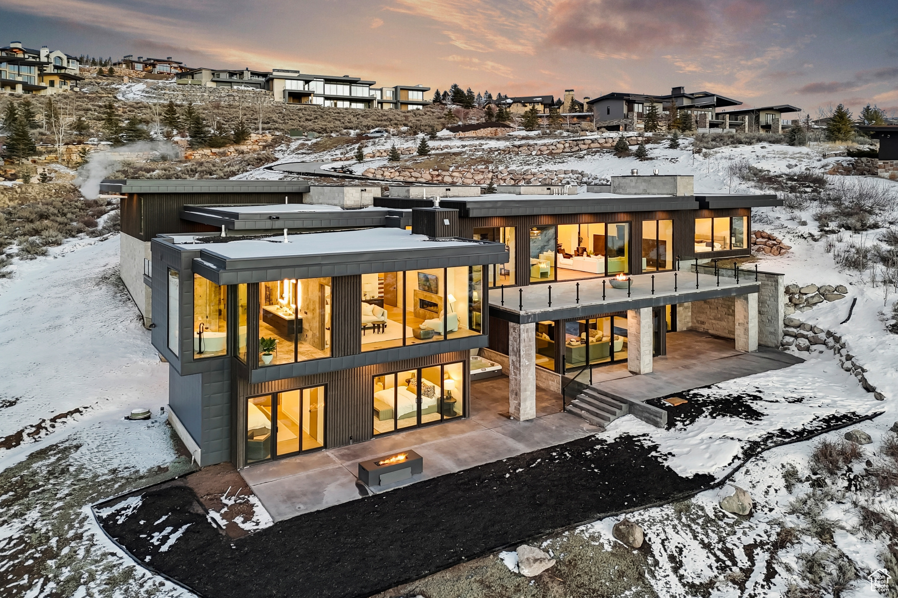 Sleek Promontory Enclave With Full Membership - This sleek and visually striking estate pushes the envelope for style in Promontory Club. Built by the renown Bailey Construction, this home combines high end contemporary design with all the essentials of luxurious mountain living. Every element of the home has been curated by Bond Design Company resulting in a fusion of elevated style with true functionality and an exceptional array of natural materials. Built to a comfortable 7,000 sq feet and fully radiant indoor and out, this home has 6 bedrooms, a spacious office, 8 bathrooms and a home gym area. Designed to be the ultimate entertainer's haven, it offers panoramic views of the Wasatch Mountain Range framed by glass walls that transition to a radiant outdoor entertaining platform. The living room exudes sophistication with a 20' graphite marble slab fireplace. The kitchen features quartzite countertops, top-of-the-line Subzero and Miele appliances, multiple dishwashers, a warming oven and a walk-in pantry. The family bar area includes a full-size wine fridge, ice maker, beverage drawers, and a separate dishwasher. The magnificent granite and LED lit staircases lead you to your preferred sanctuary within the home, choosing between the two main level oversized ensuite bedrooms and a stunning office with private deck. The primary bedroom boasts floor-to-ceiling glass, providing a special connection to nature. Stepping into the elaborate bathroom, it is adorned with backlit mirrors and a luxurious steam shower embellished with beautiful marble slabs for an ambiance second to none. The lower level has a second family room with a delightful food and beverage cove offering ultimate Game Day fun. 3 ensuite guest rooms each with its own private walkout deck, and a second junior primary suite ensure a hotel-esque feel. For those seeking an invigorating workout, a flexible gym space is also available. Furnishings are included in the purchase price and a Full Membership is available for purchase upon close of the property.