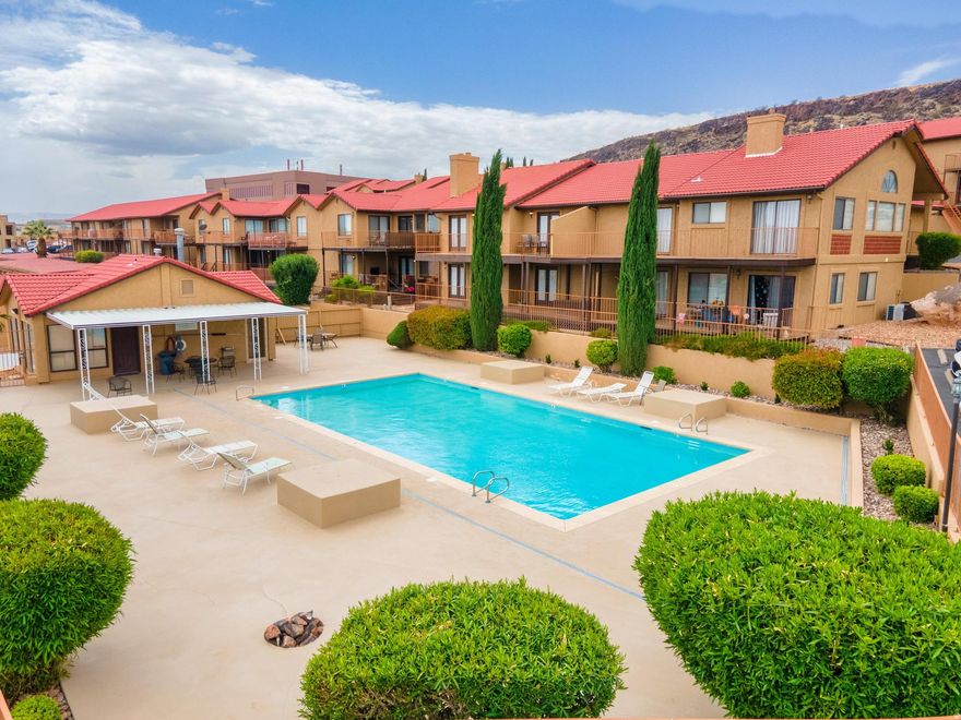 This beautifully updated end-unit condo nestled in the heart of St. George! This incredible home or investment opportunity boasts 2 bedrooms and 2 bathrooms within a spacious 1008 SF open concept floor plan. Recent updates include a modern kitchen, newer flooring, , stylish light fixtures, and a new water softener added May 2025 making this property a move-in ready dream. Enjoy breathtaking east-facing views of the city and stunning red rock bluffs from the deck, perfect for relaxing or entertaining and perfect for pets. The condo is located in a quiet end unit, providing ample space and privacy. The HOA fee is $335 per month, covering cable, exterior building insurance, garbage, internet, swimming pool access, roof maintenance, sewer, water, and yard upkeep. Buyers are encouraged to research all relevant information. Comes fully equipped with essential appliances, including a washer, dryer, and refrigerator. A detached covered carport ensures convenient parking. Priced to sell, this property is being offered in ''as is'' condition. Don't miss out on this cozy, move-in ready home with one of the best views in the entire complex!