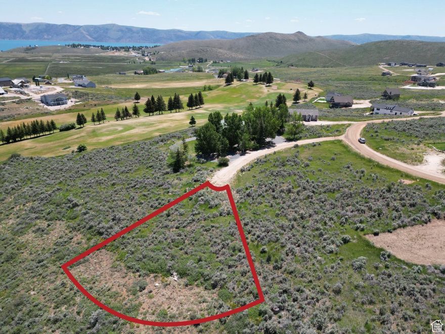 SHORT TERM RENTALS allowed. Build you dream home or vacation getaway or investment property with beautiful views overlooking the golf course and Bear Lake. Property owners in this area can purchase an amenities package from Ideal Beach, offering access to sandy Bear Lake beach, swimming pool, tennis courts, playground and more. Ride snowmobiles or ATVs directly from your lot to explore hundreds of miles of scenic mountain trails. Just minutes from Bear Lake boat launches. Come enjoy the best of Bear Lake recreation! Adjacent lot also available.