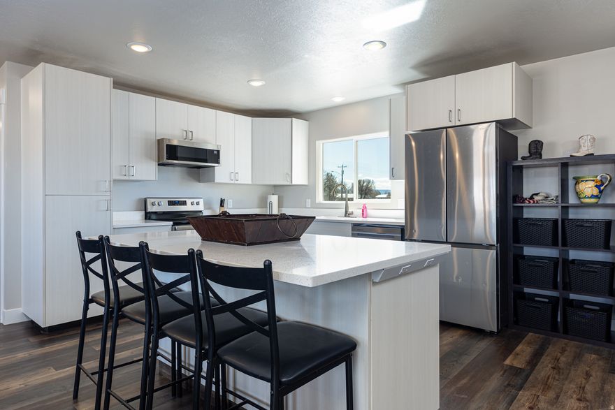 Completely rebuilt and move-in ready, this beautifully remodeled home offers a bright, modern interior and spacious open design. The large living area flows seamlessly into the dining space and features a generous island bar-perfect for entertaining or casual gatherings. Natural light fills the home, highlighting the clean finishes and welcoming layout. The primary King-sized bedroom includes a private full bath for comfort and privacy. One additional bedroom is large enough to accommodate a king-size bed, while the 3rd bedroom easily fits a queen. The main full bath also includes a stackable washer and dryer, both included in the sale for added convenience. Situated on a fully fenced .28-acre lot, the property offers plenty of outdoor space. A Connex storage container provides excellent storage for tools, toys, or equipment. In the front yard, a cut patio sits beneath a large shade tree, creating a peaceful place to relax and enjoy the surroundings. Take in the beautiful views of Arizona's iconic cliffs, adding a stunning natural backdrop to this turnkey property. A rare opportunity to own a fully refreshed home with space, views, and modern comfort. Buyer to verify to all