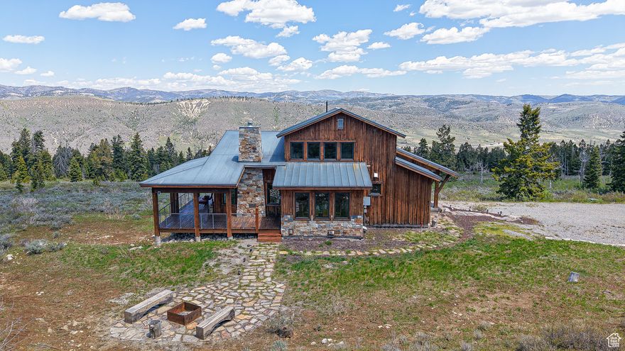 Be Sure to check out the tours! This beautiful home is the epitome of mountain living with this stunning Mountain Modern residence that effortlessly blends style and functionality. Nestled amidst breathtaking panoramic views, this home boasts an open-concept design with soaring 9" ceilings, creating a sense of expansiveness and light throughout. Step inside to discover meticulously crafted custom cabinetry and built-ins that enhance both aesthetics and storage. The gourmet kitchen is a chef's delight, featuring a spacious butler pantry complete with a sink, ensuring seamless entertaining and meal preparation. Warmth and comfort are prioritized with radiant boiler heat, supplemented by a brand-new boiler for efficiency and reliability. The expansive deck wraps gracefully around the back of the home, offering an unparalleled setting for relaxation and outdoor gatherings, all while soaking in the stunning vistas from every angle. Luxury flooring choices, including rich hardwood and polished concrete, complement the home's sleek design. For those with a passion for hobbies and storage, the detached workshop, equipped with a garage door, provides the perfect space for ATVs and toys. This property is a rare gem, offering a seamless blend of modern amenities and timeless charm in a truly spectacular mountain setting. Don't miss the opportunity to make this extraordinary home your own.