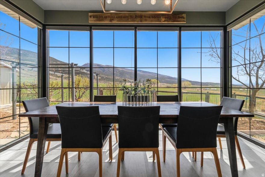 Stunning custom home tucked up Ephraim Canyon in one of the area's most desirable neighborhoods, offering incredible views of both the valley and surrounding mountains. This thoughtfully designed property features 4 bedrooms and 2.5 bathrooms in the main home, plus a fully separate ADU, creating flexibility for a variety of living situations. The main level is designed with accessibility and ease in mind, featuring step-free entry from the garage, wide open living spaces, and a beautifully finished roll-in shower. With a bedroom conveniently located on the main level and three additional bedrooms downstairs, the layout offers both comfort and functionality. No expense has been spared in this high-quality build, with elevated finishes and intentional design throughout that make the home feel both beautiful and practical. The ADU is completely separate with its own garage and entrance, making it ideal for rental income, guests, or multigenerational living. Built beneath the garage with a suspended slab, this space offers excellent privacy while maintaining durability and thoughtful construction. Situated on a fully landscaped, low-maintenance lot, the property also features mature fruit trees including apple, peach, and cherry. Enjoy the peaceful canyon setting, breathtaking views, and the versatility this property has to offer.