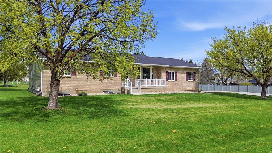 Well-maintained 1.25-acre Mendon property with space to spread out. Bright main living area with granite countertops, matching appliances, and updated bathrooms. Main level offers 2 beds/2 baths, with 3 additional bedrooms and a full bath in the walk-out basement.  Recent updates include new roof, fresh interior and exterior paint, and a 2023 boiler system. Efficient instant water heater, water softener, and heated garage.  Fully landscaped with mature trees, secondary water, garden space, pasture, and multiple outbuildings including a 14' x 24' shed/shop. Flat, usable lot with room for animals, hobbies, or extra storage.
