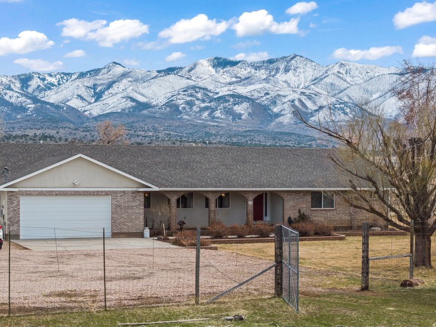 Don't miss this amazing property! This home comes with impressive amenities: A secluded location, a 1500 sq ft woodworking shop, a barn, producing fruit trees, an RV pad, a small dog run, and all on a total of 8.18 acres! The roof was recently installed in the fall of 2024. The yard features mature shade and fruit trees. The 1500 square foot heated woodshop conveniently has work tables, a vacuum system to keep down the dust, and a dust-free paint room with ventilation. The barn has a tack room and main area with a loft. The acreage is fenced off apart from the house and home yard area. Future owners could use the land for animals or development. Imagine the possibilities for this property! The seller is offering $4,000 in credit to go towards replacement of appliances.
