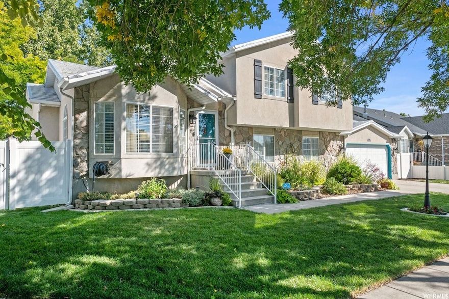 This well-maintained 5-bedroom, 3-bath West Jordan home offers timeless curb appeal with modern comfort and efficiency, ideal for growing families. The bright, open floor plan is filled with natural light from large windows and features brand-new LVP flooring and fresh carpet, creating a warm and welcoming space for everyday living and gatherings. The kitchen includes quartz countertops, all major appliances, along with a Whirlpool washer and dryer for added convenience. Energy efficiency adds long-term value with 10 owned Blu Raven solar panels (2.6 kW), helping keep utility costs down year-round. The durable metal shingle roof and HVAC system with 8 years of warranty remaining provide peace of mind. Additional features include a humidifier, water softener, smart thermostat, security system, and smart sprinkler controls. Enjoy family movie nights by the built-in fireplace and 3D TV wall, or let the kids play in the fully fenced backyard complete with a pergola, play area, and a 300 sq. ft. shed for extra storage. Conveniently located near Jordan Landing, offering easy access to shopping, dining, entertainment, and everyday essentials, this move-in ready home is designed for comfort, convenience, and family living.