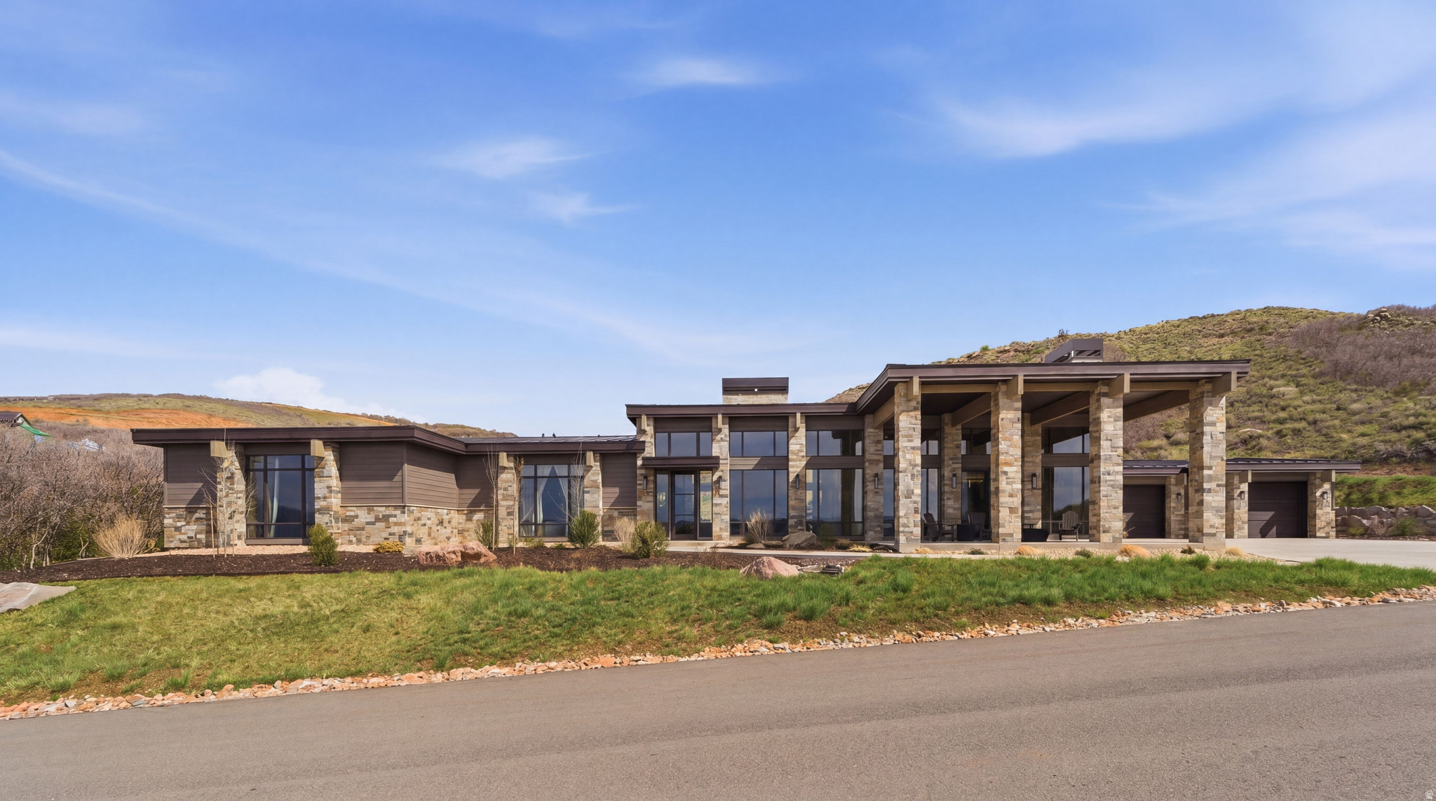 Contemporary single-story residence with a stone and wood siding exterior