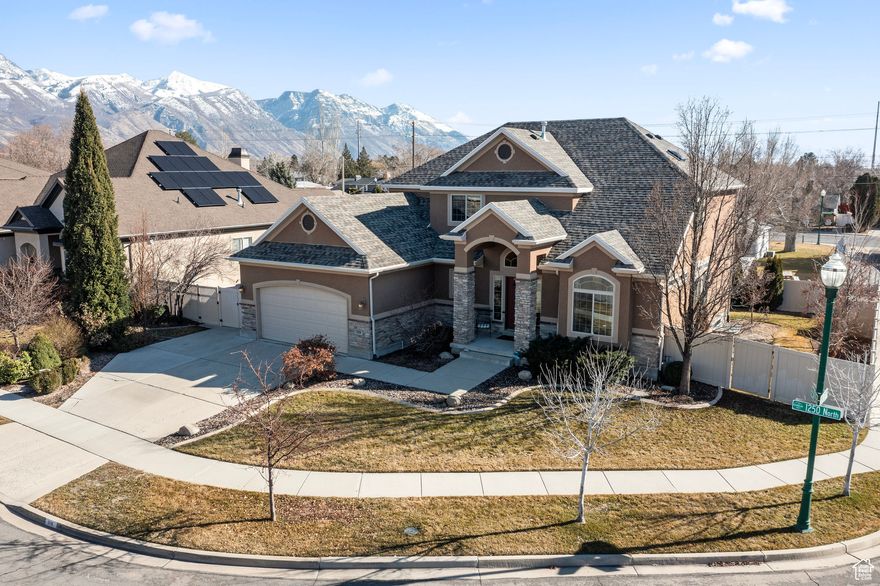 Located just a short walk from Timpanogos High School and minutes from premier shopping, dining, and scenic hiking trails, this beautifully maintained home offers the perfect blend of convenience and comfort. Enjoy unobstructed views of majestic Mount Timpanogos from the front of the home, and relax in the professionally landscaped backyard-an ideal setting for outdoor relaxation or quiet evenings. Step inside to an inviting open-concept kitchen, dining, and living area, designed for effortless entertaining and everyday living. The fully finished basement features a custom, professionally installed theater room that opens through elegant French doors to a spacious bonus flex area, perfect for game nights, large gatherings, or a home gym. Additional highlights include a new roof installed in November 2024 and thoughtful updates throughout. Square footage figures are provided as a courtesy estimate only and were obtained from county records. Buyer is advised to obtain an independent measurement.