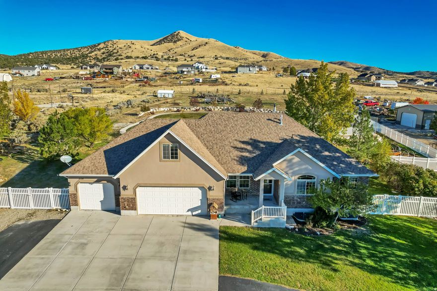 Gorgeous 6-Bedroom Home on 2 Acres - Fully Upgraded with Exceptional Outdoor Amenities  Discover the perfect blend of luxury, functionality, and space in this beautifully designed 6-bedroom, 3.5-bathroom home set on 2 acres of landscaped grounds in the desirable South Rim neighborhood of Tooele County, just outside Stockton City.  This meticulously maintained property offers high-end finishes, thoughtful design, and versatile living options throughout. The spacious kitchen is a chef's dream-featuring dual sinks, premium upgrades, and an expansive walk-in butler's pantry with counters, drawers, and abundant storage. A second kitchen adds flexibility for entertaining, multi-generational living, or a potential mother-in-law setup.  The finished basement includes a separate entrance and can easily function as a self-contained apartment. Inside, soaring vaulted ceilings, bright open spaces, and a bonus room above the garage create an inviting atmosphere perfect for family living or hosting guests. The 3-car garage includes an extra-deep bay and convenient basement access. Fiber optic internet ensures fast, reliable connectivity-ideal for remote work or home-based businesses.  Step outside to enjoy a stunning outdoor oasis. The fully fenced backyard is designed for recreation and relaxation, featuring a spacious deck with gazebo, a 10-foot fenced sports court with oversized basketball hoop, a 330-foot concrete walking loop, an in-ground trampoline, and a 12x12 sandbox. Gardening enthusiasts will appreciate multiple raised garden beds, mature perennials, and fruit trees producing peaches, apples, and pears. Mature shade trees, lush landscaping, and animal rights for horses or livestock enhance the property's country charm.  An undeveloped portion of the acreage offers exciting possibilities for future expansion, additional outbuildings, or pasture space-ready to be customized to your vision. Enjoy panoramic mountain views, a friendly community atmosphere, and convenient access to local parks, ATV/horse trails, nearby services, and the city of Tooele for shopping and amenities.  Located just 4560 minutes from Salt Lake City, this property offers the rare combination of tranquility, space, and accessibility. A must-see for discerning buyers seeking quality craftsmanship, flexibility, and an unparalleled lifestyle.  Square footage figures are provided as a courtesy estimate and were obtained from the seller. Buyer is advised to obtain an independent measurement.