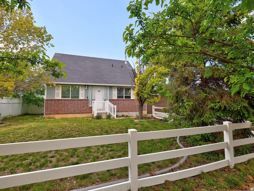 Wonderful Roy home on a quiet street. Large yard complete with fence, covered patio, and storage shed.  This home has a great floorplan. Kitchen has tastefully updated cabinets, tile backsplash, and stainless steel refrigerator. Main level bedroom and 3 bedrooms upstairs. Main level laundry. Large living room for entertaining. Laminate flooring in most high-traffic areas. Large garage is extra wide and the full depth of the house. The furnace and water heater are in the garage to keep the noise out of the house. Large backyard shed for all your storage needs. Double-paned windows throughout.