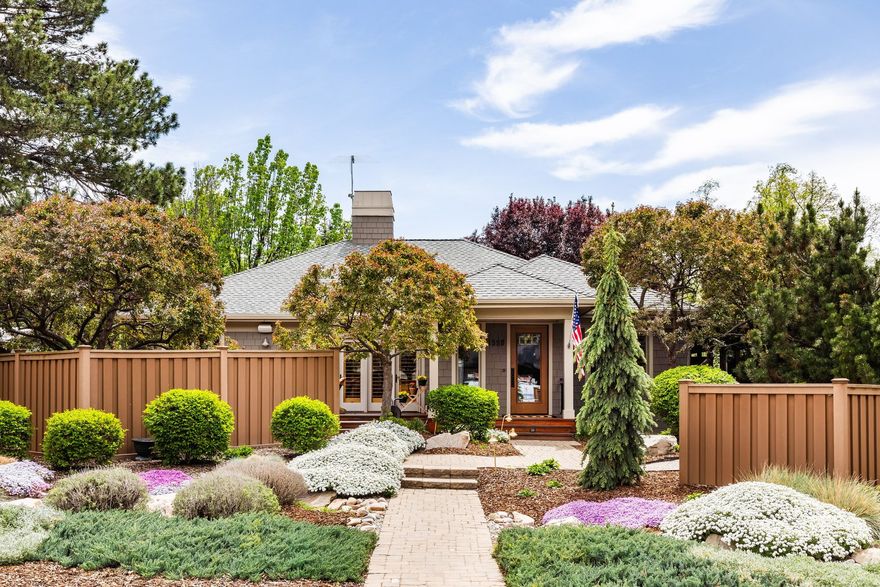 Welcome to this truly exceptional Craftsman home, where every detail has been thoughtfully curated and meticulously maintained. A true "jewel box," this residence reflects years of dedicated care-every surface gleams, every garden bed is perfectly tended, and the pride of ownership is unmistakable. Inside, you'll find an elegant, light-filled floor plan with soaring vaulted ceilings, rich woodwork, and expansive windows that flood the home with natural light. The chef's kitchen is both beautiful and functional, featuring generous counter space, stunning cabinetry, and a hidden pantry-perfect for seamless entertaining. The main-level primary suite is a serene retreat, complete with a cozy fireplace, spacious walk-in closet, and direct access to the outdoors. Brazilian cherry hardwood floors run throughout, adding warmth and sophistication. Designed with entertaining in mind, the house offers inviting outdoor living spaces. Downstairs, a cozy family room provides ample seating and tranquil views of the stunning outdoor waterfall, along with two additional bedrooms featuring egress windows. Step outside to your own private sanctuary-an extraordinary backyard with mature trees, winding paths, and thoughtfully designed outdoor living spaces. Enjoy evenings on the beautiful patio with a built-in firepit, or practice your short game on the expansive putting green. Car enthusiasts will appreciate the rare three-car detached garage, fully equipped with a built-in vacuum, tire inflator, fans, and a dedicated workbench.