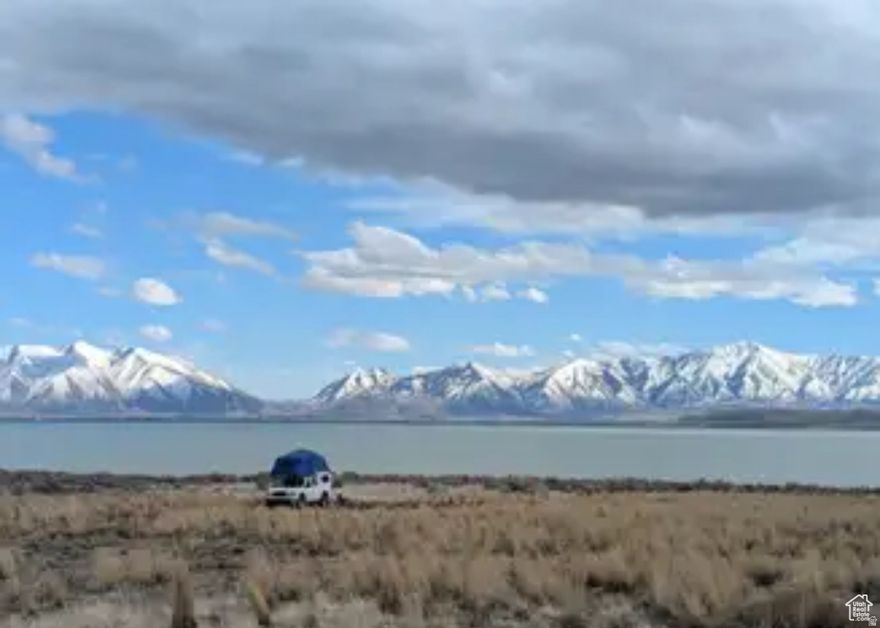 Just 7 miles south of Saratoga Springs on the west side of Utah Lake with spectacular lake and mountain views. Build a home out in the country, or use for recreation. Utah County has given preliminary approval to build a single-family home on this lot, with a paved access road put in. Electricity accessible to bring to the lot, and water shares can be purchased with the ability to drill a well. Grab a great piece of property at a great price! The lot is in the Mosida Orchards subdivision, which long-term will have the opportunity of a master planned community and the potential to sell off this land to a developer for a nice profit if desired in the future.