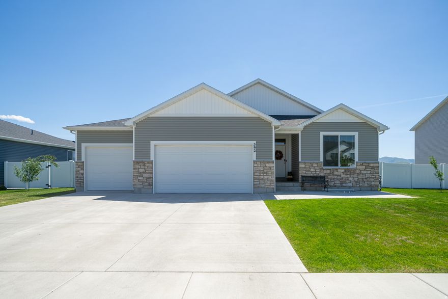 Stunning 6-bedroom home on the beautiful south end of Cache Valley. Discover the perfect blend of space and function in this fully finished 3,150 sq. ft. home. Boasting 6 spacious bedrooms and 3 baths.  Huge 4 car garage offers abundant storage for all your gear. Situated on a large, fully fenced lot,  the yard features auto sprinklers, oversize patio and varieties of young fruit trees, still with plenty of room to play. Located minutes from grocery and hardware store, Hyrum State Park and Reservoir for boating and fishing, plus premier hiking, biking, and one of the West's top skate parks with lighted pickleball and splash pad and dog park. Your ultimate outdoor lifestyle starts here!