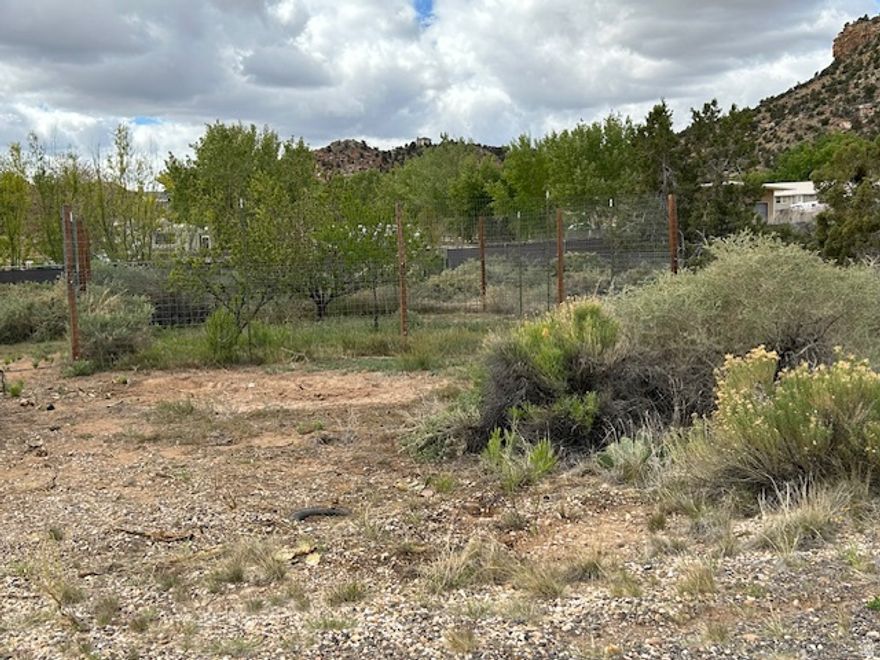 Gorgeous views of Escalante Canyons! Almost 1/2 lot situated at north end of town near the River and located at end of road. North facing with all utilities nearby and in street. Water meter / impact fee has been paid for. Bring your own builder with no HOA or CCR's. Partial fencing on back and side.