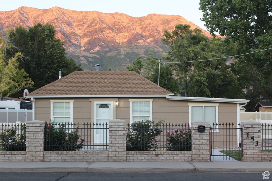 Three years ago, this cozy cottage was treated to a complete makeover. It has new electrical, on-demand water heater, shingles, lighting fixtures, bathroom counters and sinks, master bathroom shower, oven and range, kitchen cabinets, and flooring. All of the ductwork was professionally cleaned. The master bedroom has a private bathroom and a walk-in closet. The home is surrounded by a large, fully fenced yard. Automatic drip and sprinkler systems supply water to the lawns, orchard, and spacious garden area. A shed next to the home provides plenty of storage space. A towering mature tree dapples the back lawn with shade, making it a lovely place to enjoy the mountain views. The property sits in a sea of friendly neighbors and great schools. Sundance Ski Resort is a fifteen-minute drive up Provo Canyon. Orem City Library, the weekly Orem Farmer's Market, and The Shops at Riverwoods are all three minutes away by car.