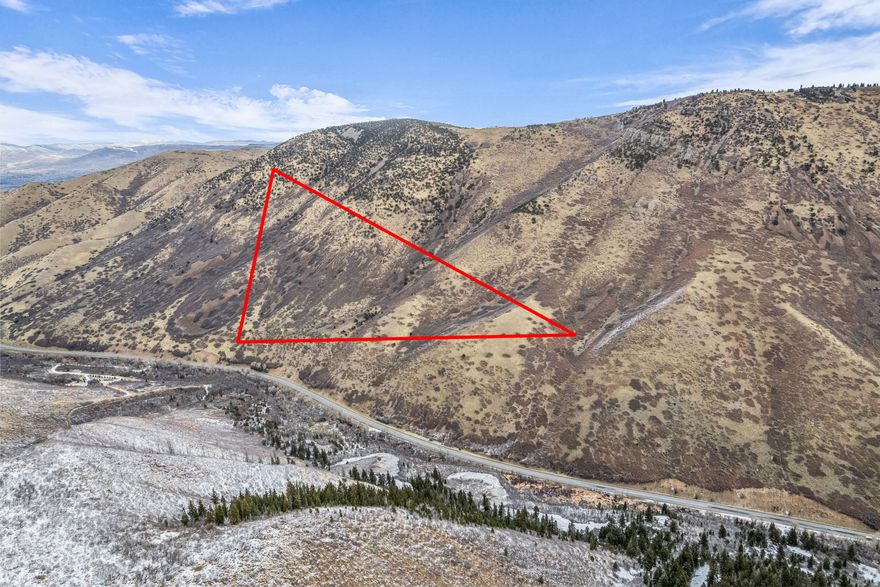 Experience 261 acres of exceptional mountain land with direct frontage on Highway 40 and expansive views across the surrounding valleys and ridgelines. Zoned P-160 and already annexed into the Town of Independence, this property offers rare long-term potential.    The property features a mix of forested hillsides and open sagebrush terrain, creating a diverse landscape.  Outdoor enthusiasts will appreciate nearby access to Daniels Summit Lodge, Strawberry Reservoir, and the extensive trail systems throughout Wasatch Mountain State Park. Located just 6 miles from the Heber Valley Hospital and minutes to shopping and dining, this is a rare opportunity to secure a large, scenic acreage parcel in one of Utah's most desirable recreational corridors.