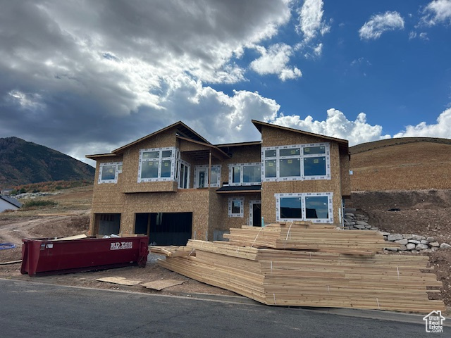 Mountain-Modern styled home dramatically set high up on the hillside above the city - true "East-Bench" living at an amazing price! A multitude of generously-sized windows direct the occupants gaze to the surrounding beauty of nature and the city. Spacious rooms, modern iron railings, white cabinetry and granite countertops adorn the living space. Enjoy sitting on the covered front deck overlooking the view or relax on the rear covered patio. Large Primary Bedroom with vaulted ceilings, large walk-in closet and separate tub/shower and two sinks in the adjacent bathroom. 4th bedroom can easily be an office. The lower level features a full one-bedroom apartment (sans kitchen cabinetry) with separate entrance! Come envision your life in this amazing home! Taxes are approximate as they have never been assessed on built home on the property.