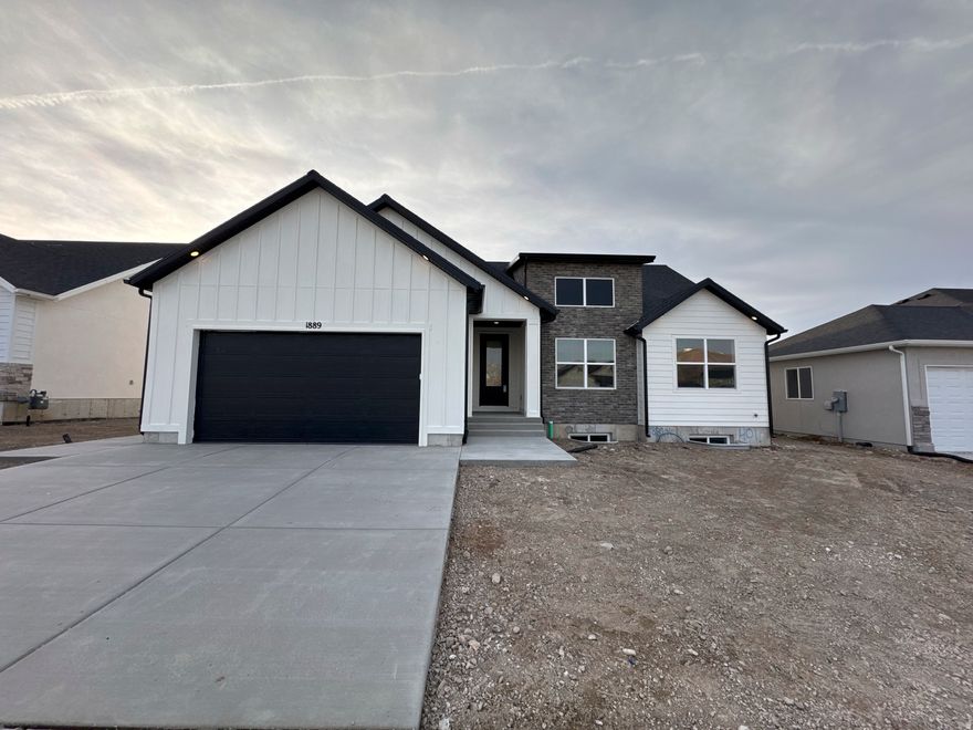 The Chelsea by GTM Builders is now offered with up to $24,000 in incentives! This beautifully designed rambler sits on a .16-acre lot in Tooele and features 6 bedrooms, 3 bathrooms, and a 2-car garage. With 3,181 total square feet, this home includes a 100% finished basement, providing ample space for living, entertaining, or multi-generational needs. Front landscaping is included, adding to the home's curb appeal. A fantastic opportunity to own a spacious, thoughtfully designed home with exceptional value don't miss it!