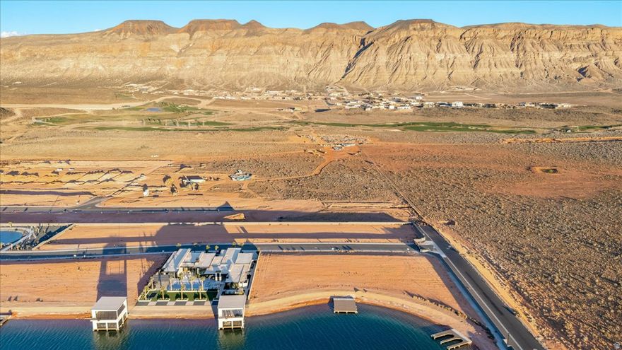 Rare opportunity to own one of the last remaining waterfront homesites in the exclusive Southern Shores wake lake community in Hurricane. Positioned along the crystal-clear shoreline with direct water access, this premium lot offers the perfect setting to build a custom lakefront retreat surrounded by Southern Utah's stunning red rock scenery and mountain views.  Start your mornings on calm glassy water, spend the day paddleboarding, surfing, boating, or wakeboarding just steps from your backyard, and end each evening with unforgettable desert sunsets reflecting across the lake. The private boat dock is already in place, with the option to build a fully customized boathouse tailored to your vision and lifestyle.  Southern Shores is a one-of-a-kind waterfront community featuring a rare three-lake system designed for every type of water enthusiast, including a dedicated boat lake, a cable lake with wakeboarding obstacles, and a surf lake engineered for endless waves. Residents also enjoy resort-style amenities including a clubhouse, pickleball courts, tennis courts, and sand volleyball.  Located just minutes from Sand Hollow Reservoir, championship golf, hiking, biking, and endless outdoor recreation, this homesite delivers the perfect balance of adventure, luxury, and privacy. Bring your own builder and design a modern masterpiece with seamless indoor-outdoor living, expansive entertaining spaces, and panoramic waterfront views.  Waterfront opportunities like this are exceptionally rare in Southern Utah. Build the lakefront lifestyle most people only dream about.